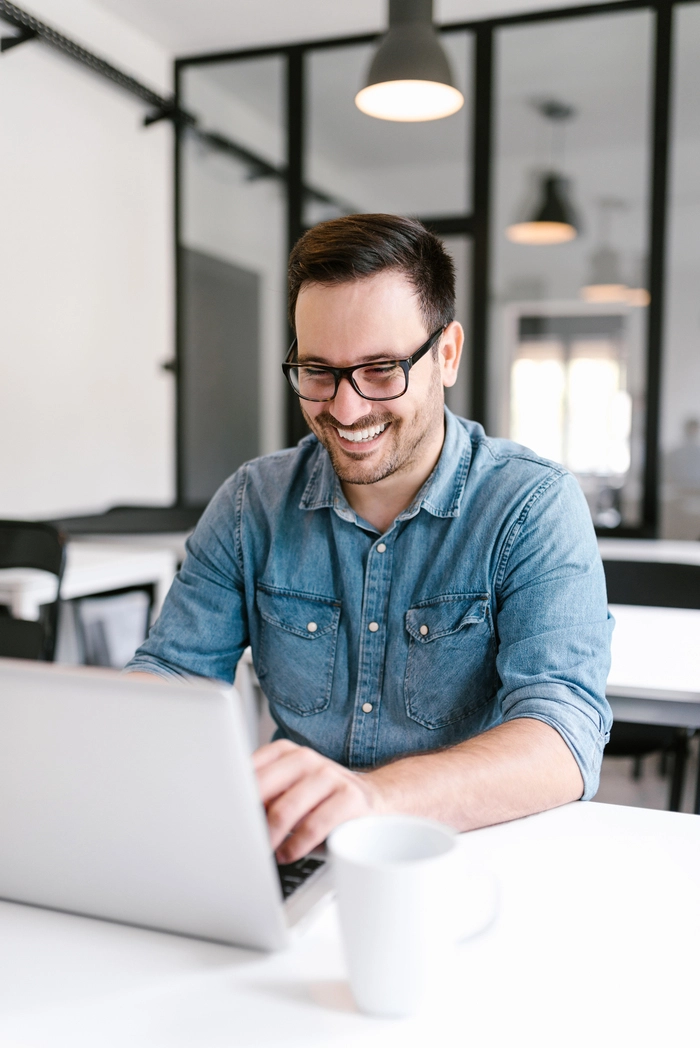 smiling-young-man-using-laptop